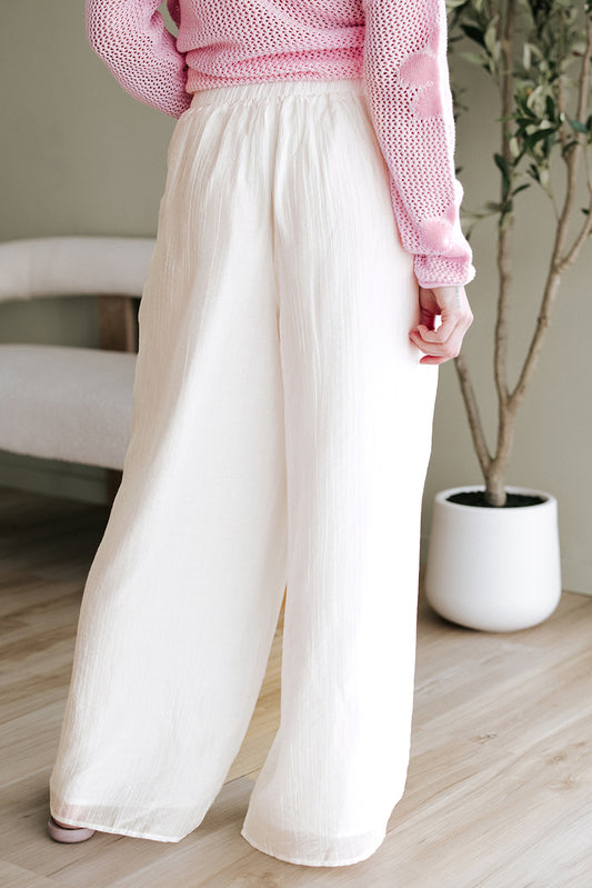 Pantalones blancos casuales con cintura plisada y pierna ancha