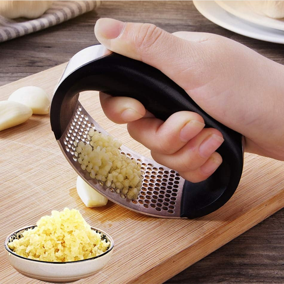 Curved stainless steel garlic crusher