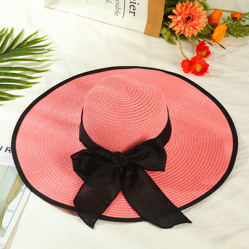 Sombrero versátil de ala grande con lazo decorativo