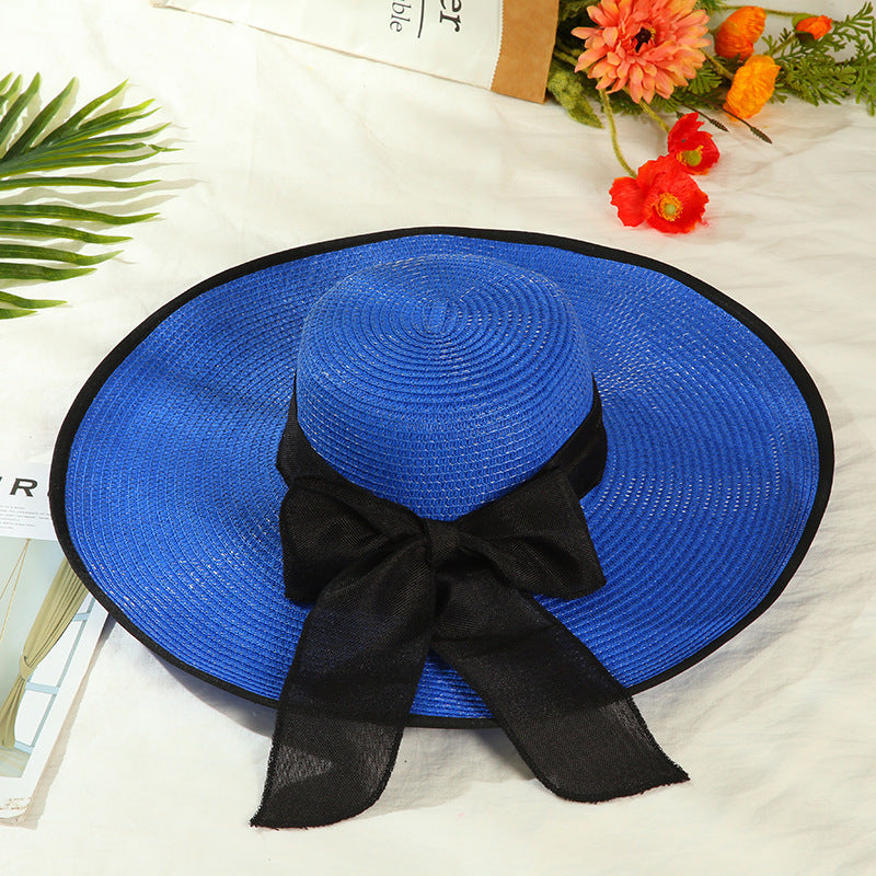 Sombrero versátil de ala grande con lazo decorativo