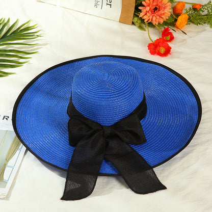 Sombrero versátil de ala grande con lazo decorativo