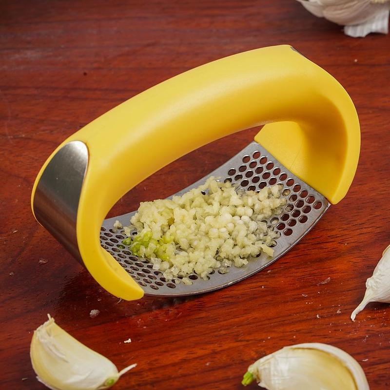 Curved stainless steel garlic crusher