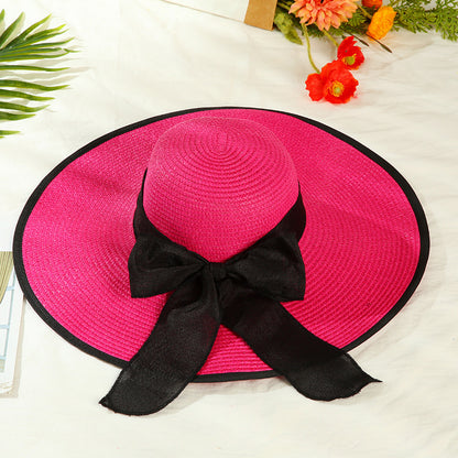 Sombrero versátil de ala grande con lazo decorativo