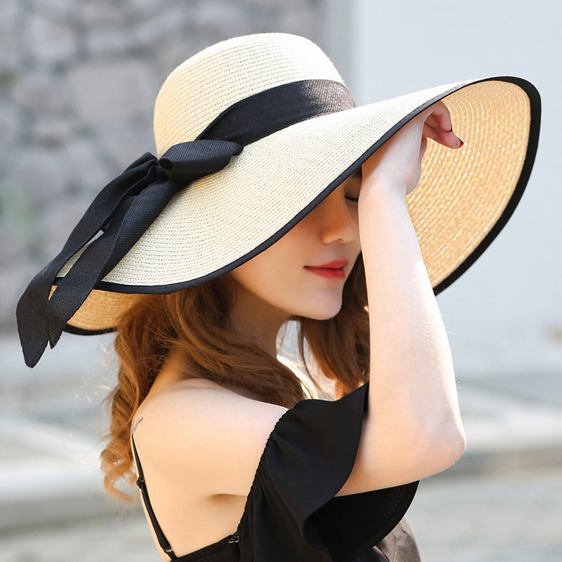 Sombrero versátil de ala grande con lazo decorativo