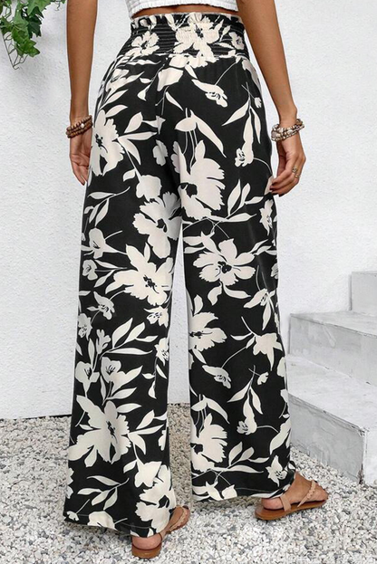 Pantalones anchos de cintura alta con fruncido y estampado floral negro