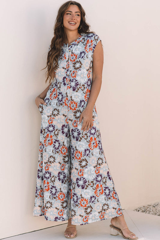 Mono de pierna ancha con bolsillos botones sin mangas con estampado floral azul cielo