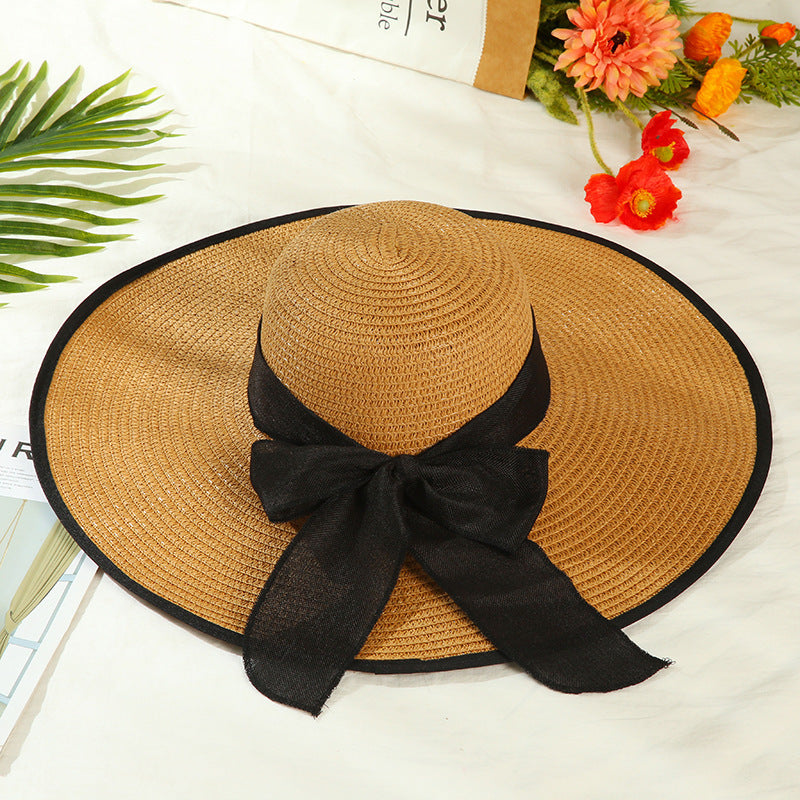 Sombrero versátil de ala grande con lazo decorativo