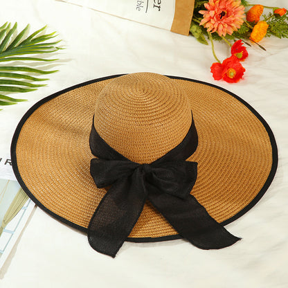 Sombrero versátil de ala grande con lazo decorativo