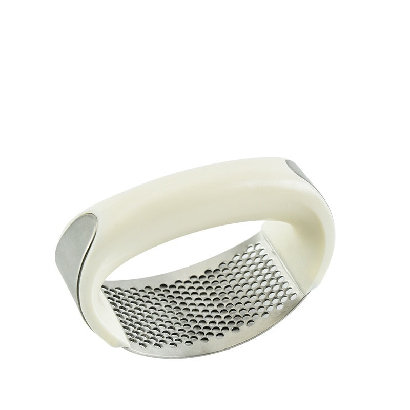 Curved stainless steel garlic crusher