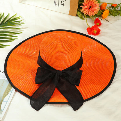 Sombrero versátil de ala grande con lazo decorativo
