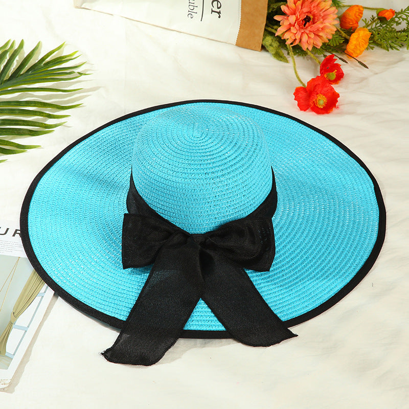 Sombrero versátil de ala grande con lazo decorativo