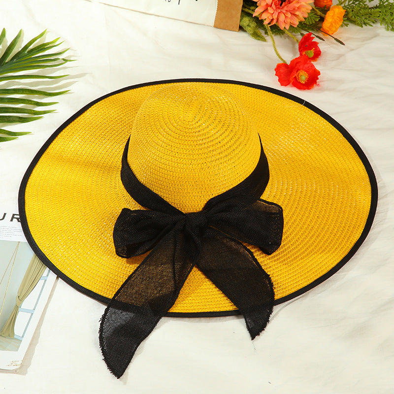 Sombrero versátil de ala grande con lazo decorativo