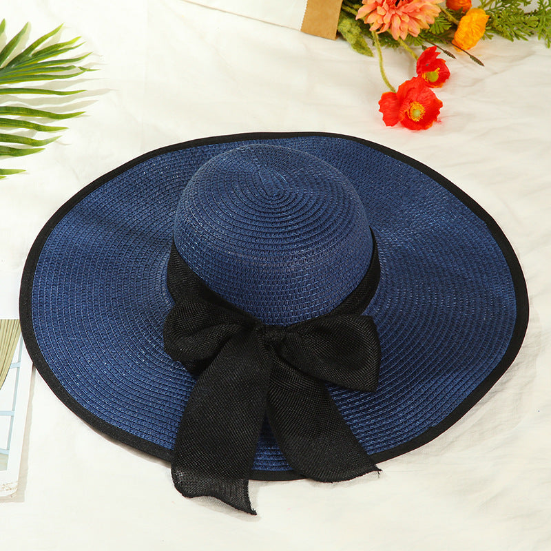 Sombrero versátil de ala grande con lazo decorativo