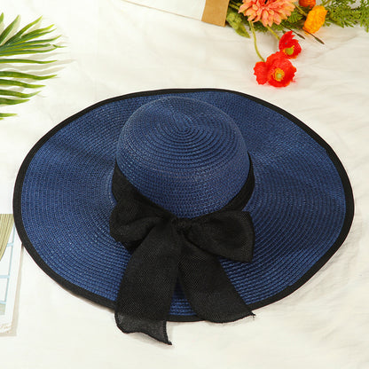 Sombrero versátil de ala grande con lazo decorativo