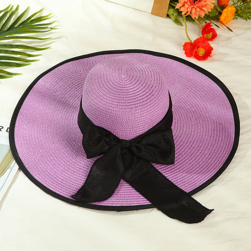 Sombrero versátil de ala grande con lazo decorativo