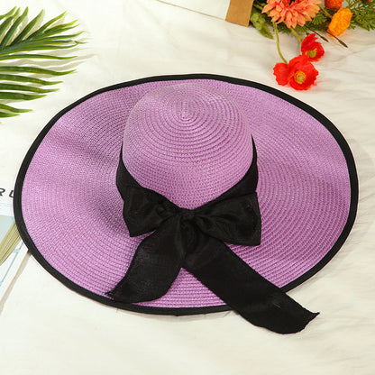 Sombrero versátil de ala grande con lazo decorativo