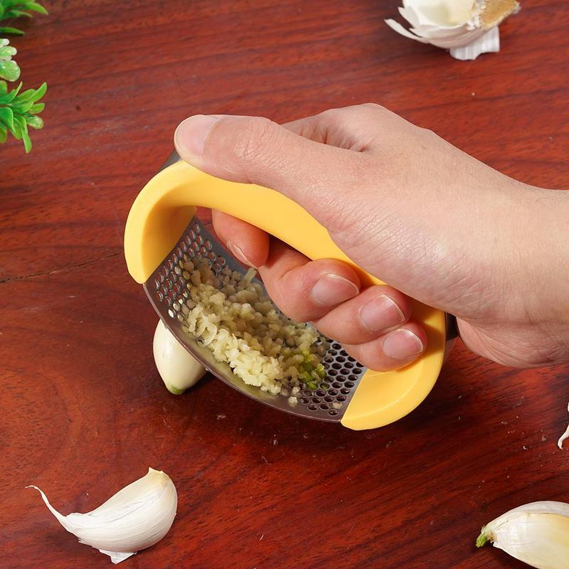 Curved stainless steel garlic crusher