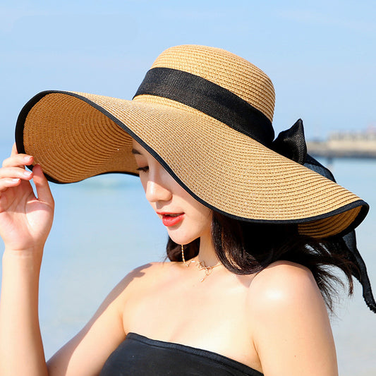 Sombrero versátil de ala grande con lazo decorativo