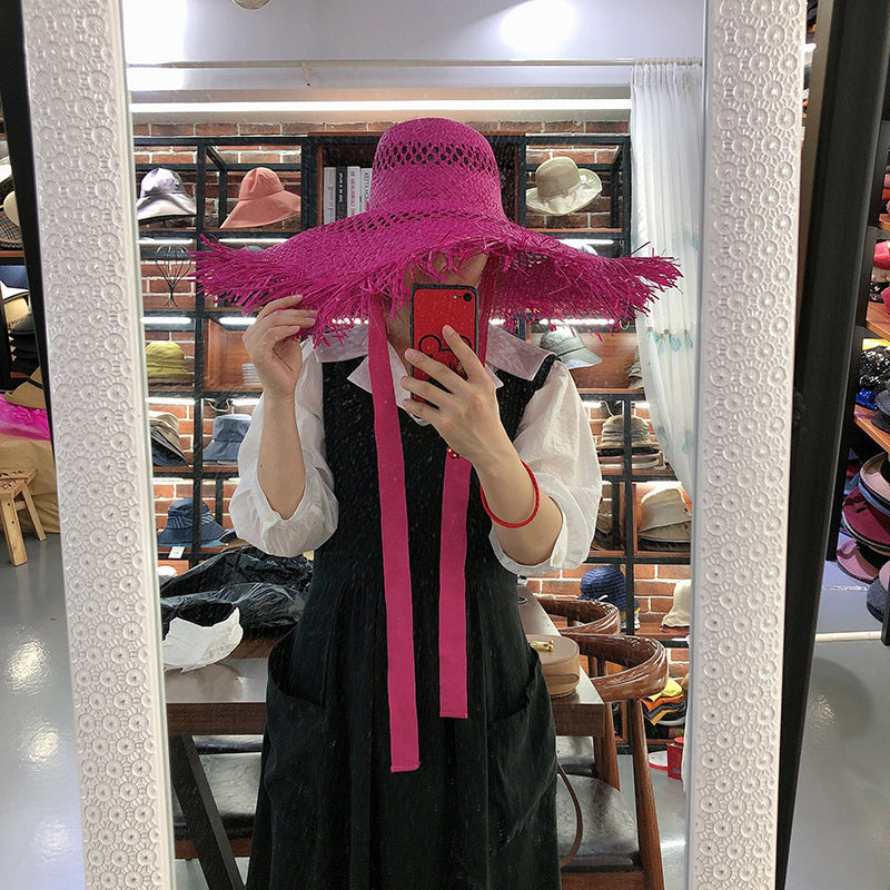 Sombrero de rafia con ala grande y borlas
