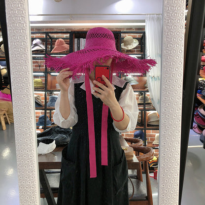 Sombrero de rafia con ala grande y borlas