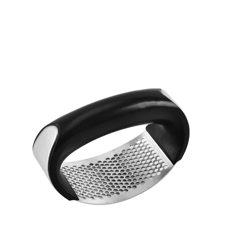 Curved stainless steel garlic crusher