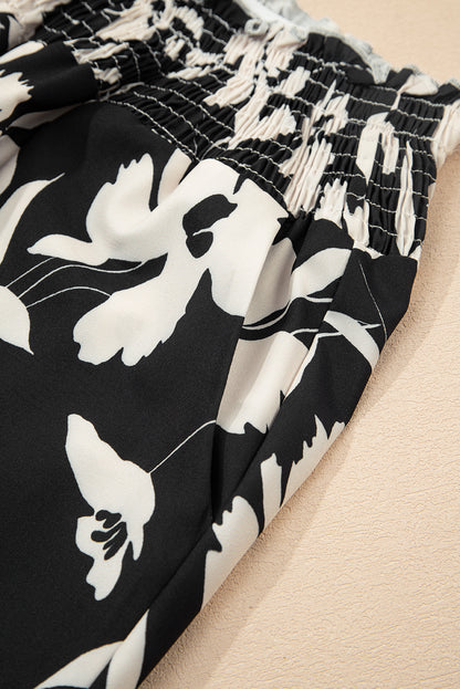 Pantalones anchos de cintura alta con fruncido y estampado floral negro